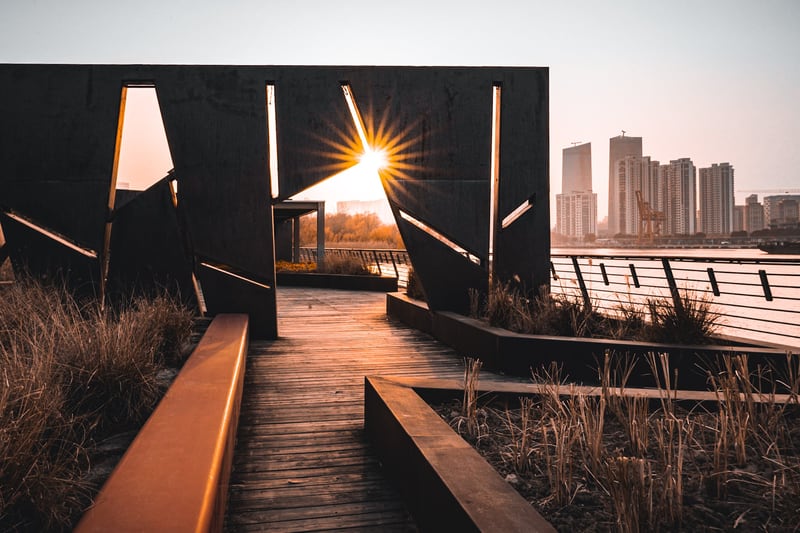 This thick steel plate — one of several on the site — is embedded in glass on the Reed Platform, which extends into the Huangpu River from the edge of the Shanghai World Expo Houtan Wetland Park. The park was originally the site of the Iron and Steel Factory (Pudong Iron &amp; Steel Group) and the Houtan Ship Repair Factory. The rough-surfaced steel plates have the appearance of ship hull material. Although stylized as “Reed’s Platform" on nearby English-language signage, the name of the platform is 芦荻台 "reedgrass platform", and it incorporates fields of reeds into its design.